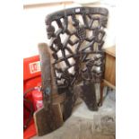 A carved ethnic two part chair with pierced back and carved figures etc