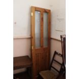 A pair of 20th Century pine doors with etched glass panels