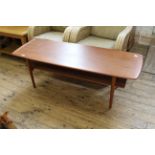 A vintage Danish mid Century two tier teak coffee table by Povl Dinesen