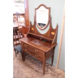 An Edwardian inlaid mahogany dressing table with shield mirror