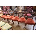 A set of six mid Victorian rosewood dining chairs with carved backs and cabriole legs