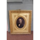 A late 19th Century French portrait photo of a gentleman in an oval gilt mount within a heavily