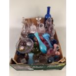 A box of mixed clear and coloured glassware including paperweights,
