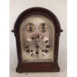 A Georgian style oak cased bracket clock with silvered dial, with striking,