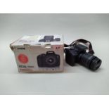 A Canon EOS 750D camera body with a 18-55mm lens and charger in original box