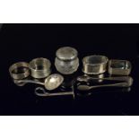 A mixed lot of silver including four napkin rings, silver lidded pot, silver tongs etc,