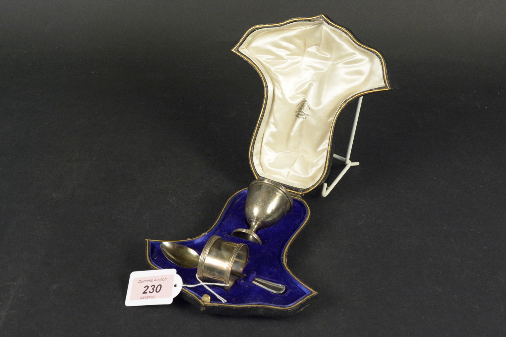 A boxed silver christening set comprising of an egg cup, napkin ring and spoon (spoon is associated,