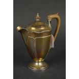 A silver water jug with flared base and wooden handle, marks are slightly rubbed,