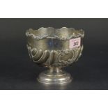 A silver bowl on pedestal base with applied and embossed floral decoration,