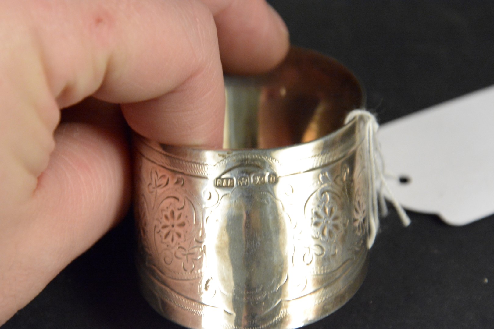 A silver napkin ring of slanted shape with engraved floral decoration, hallmarked Sheffield 1896, - Image 3 of 3