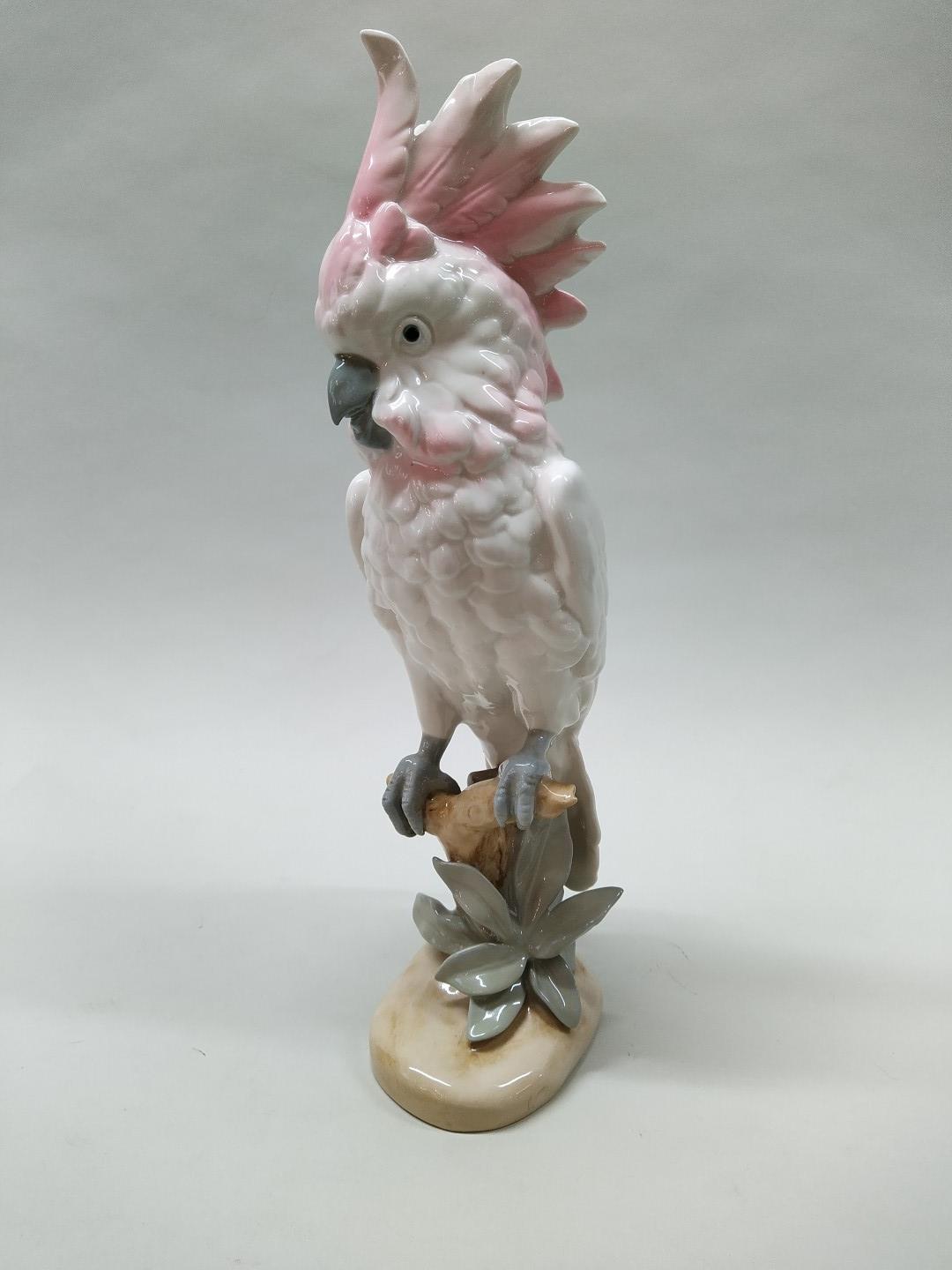 An early 19th Century Royal Dux, pink pad mark cockatoo on perch,
