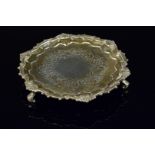 A small silver salver with shell border and engraved centre, hallmarked London 1830 (repaired legs),