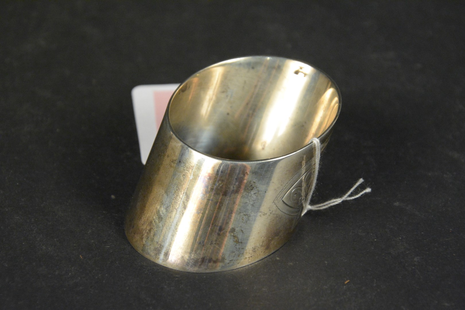 A silver napkin ring of slanted shape with engraved floral decoration, hallmarked Sheffield 1896, - Image 2 of 3
