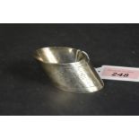 A silver napkin ring of slanted shape with engraved floral decoration, hallmarked Sheffield 1896,