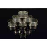 A set of six silver floral engraved napkin rings (all with engraved monogram),