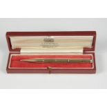 A 9ct gold engine turned propelling pencil, London 1959, length 10.