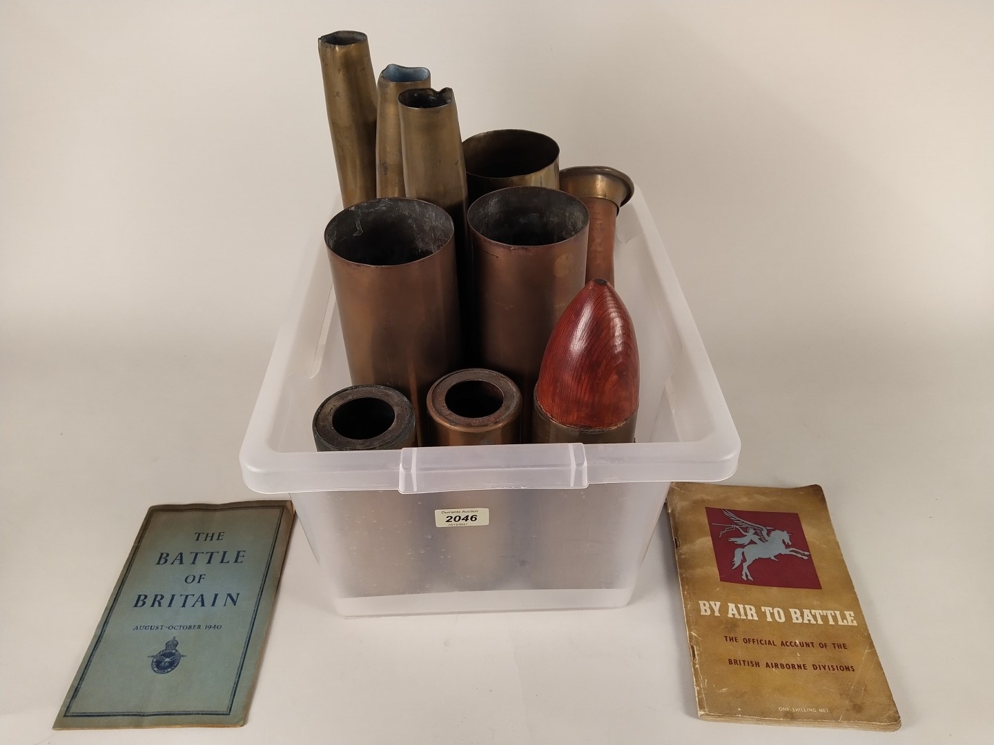 A collection of ten brass shell cases (WWII dated and later) with a copper and brass bugle and two
