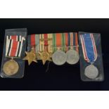 A WWII mounted group of four including Africa Star with 8th Army clasp with unnamed Coronation and