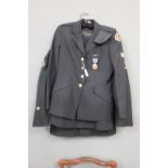 Two U.S.A. military jackets, one with skirt and cap