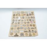 A card of sixty seven various military cap badges