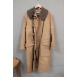 A WWII cold weather coat, label reads 'Coat Kapok Lined, Size 3' etc,