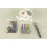 A mixed lot including WWII pair, mainly Red Cross insignia etc with a nursing cup and an A.T.