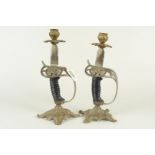 A pair of 'military' themed candlesticks modelled from the hilts of two Imperial German Wurttemberg