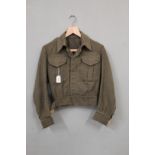 An Australian battle dress blouse (size 4) dated 1941 with Captains pips and Royal Norfolk Regiment