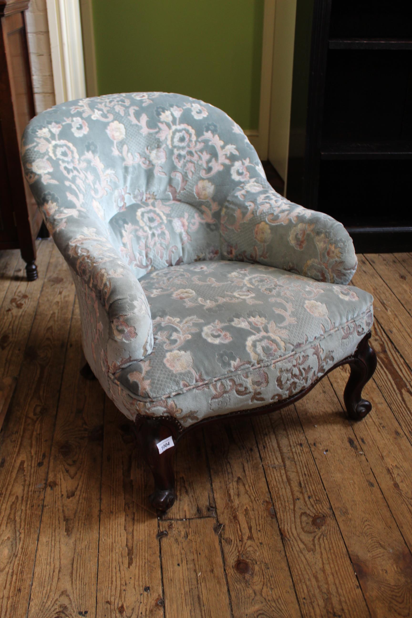 A mid Victorian carved mahogany upholstered armchair