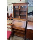 An early 20th Century oak glazed bureau bookcase with adjustable shelf to bottom
