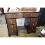 An early 19th Century mahogany leather topped eight drawer desk on shaped bracket feet