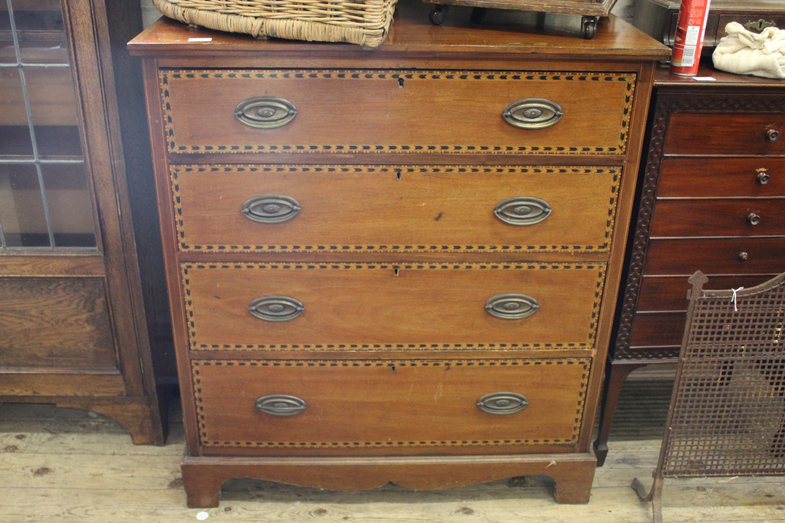 An Edwardian inlaid mahogany four drawer chest