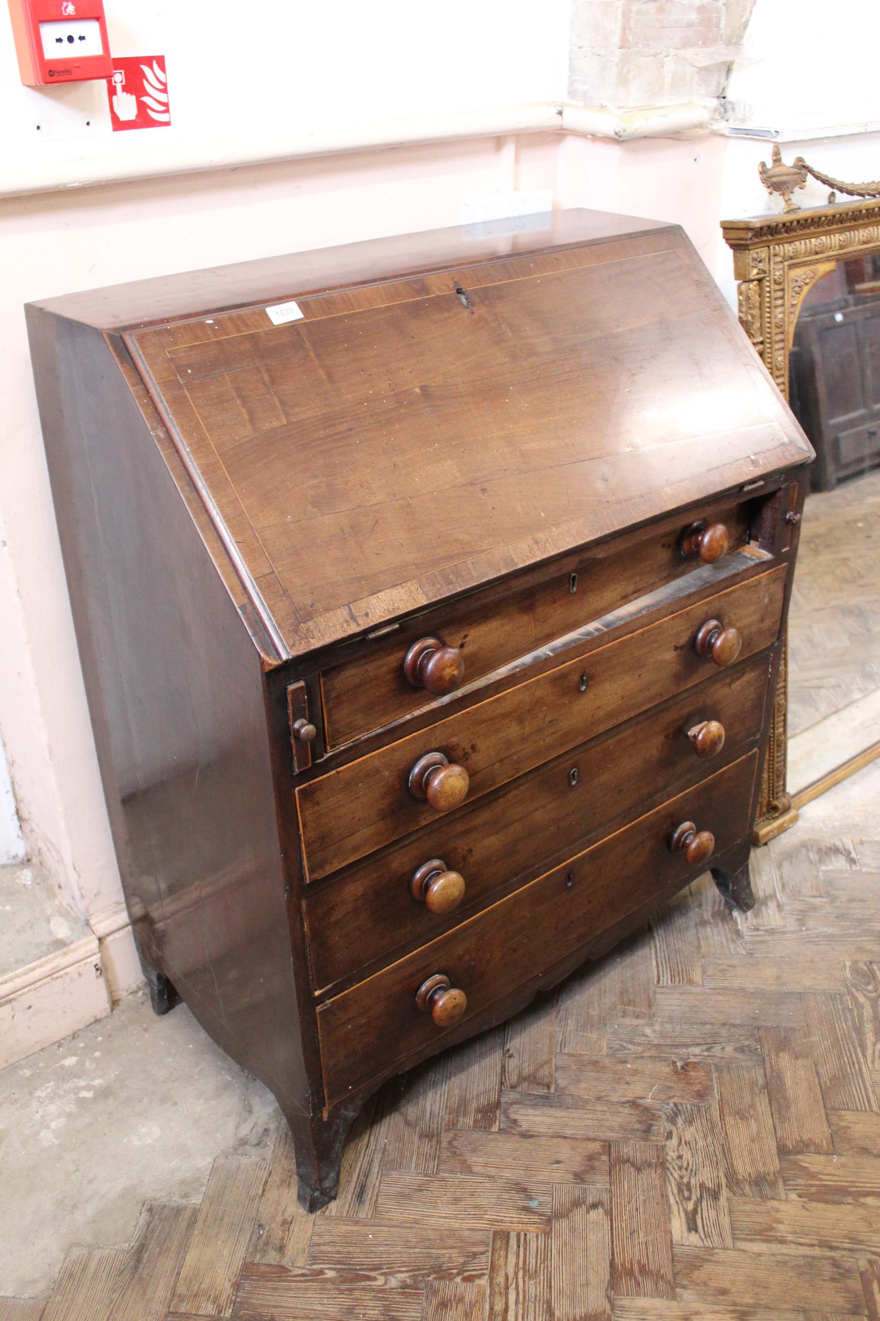 An early Victorian mahogany four drawer bureau on splayed feet (interior as found)