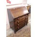 An early Victorian mahogany four drawer bureau on splayed feet (interior as found)