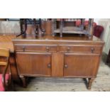 An early 20th Century oak two door, two drawer sideboard with Deco style upstand,