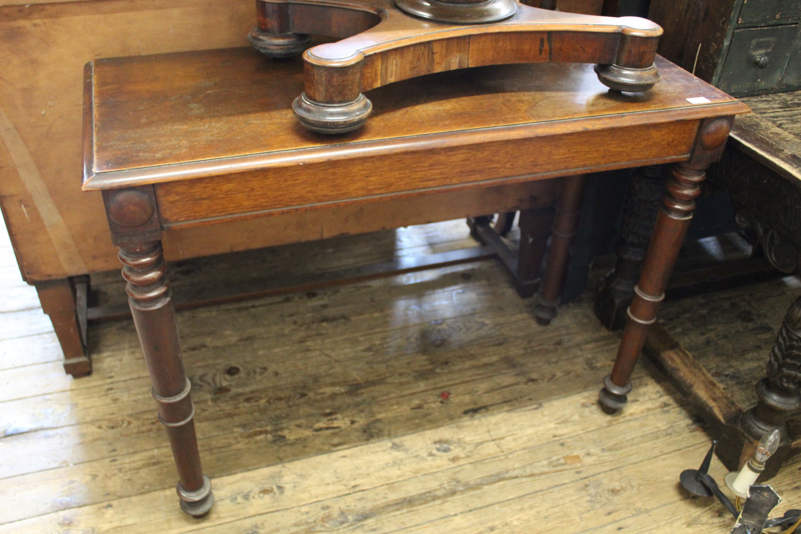 A late Victorian oak side table on turned legs