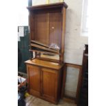 A late Victorian mahogany two door cupboard bookcase with mirrored back