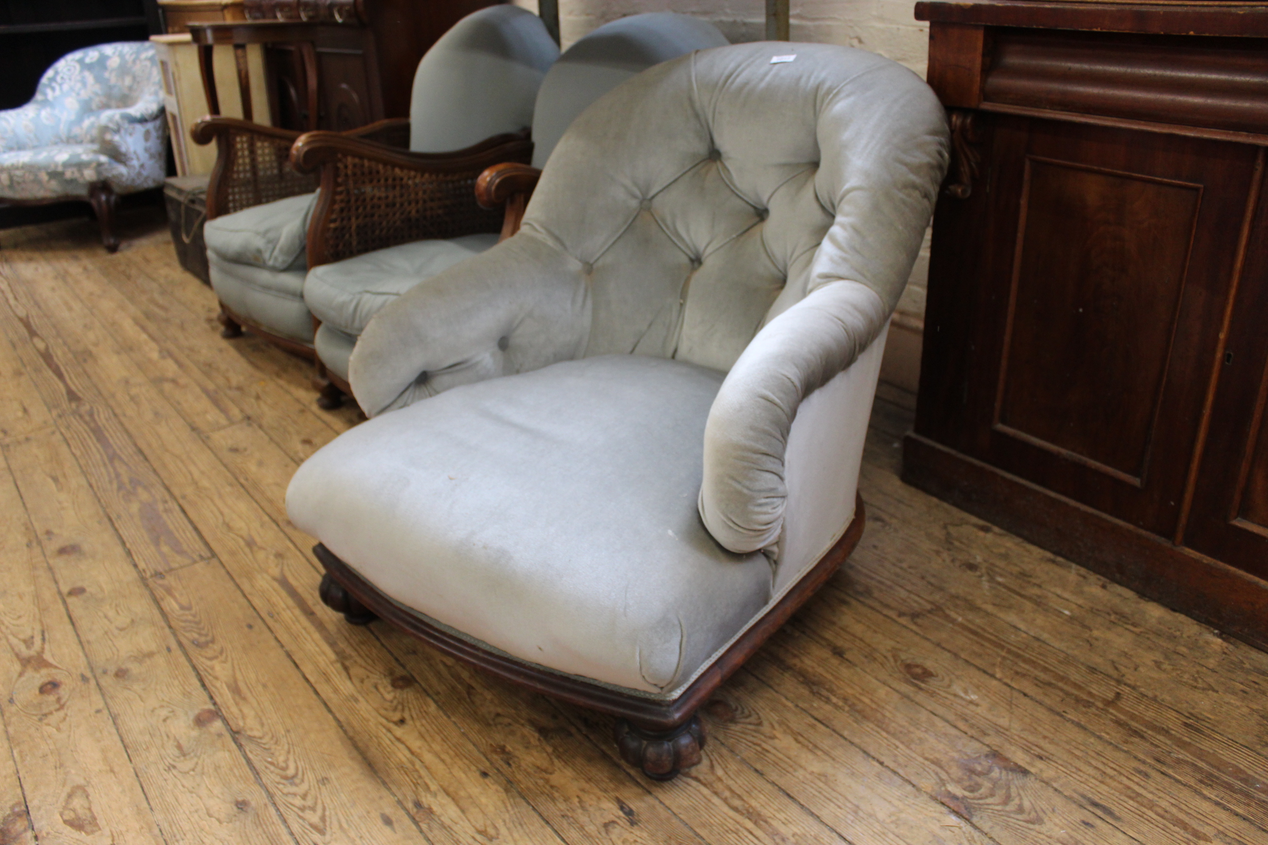 A mid Victorian carved mahogany button back low arm chair