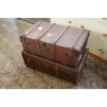 A vintage canvas and wood bound trunk plus another travelling trunk