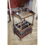 A Victorian rosewood Canterbury with carved upstand and drawer to base