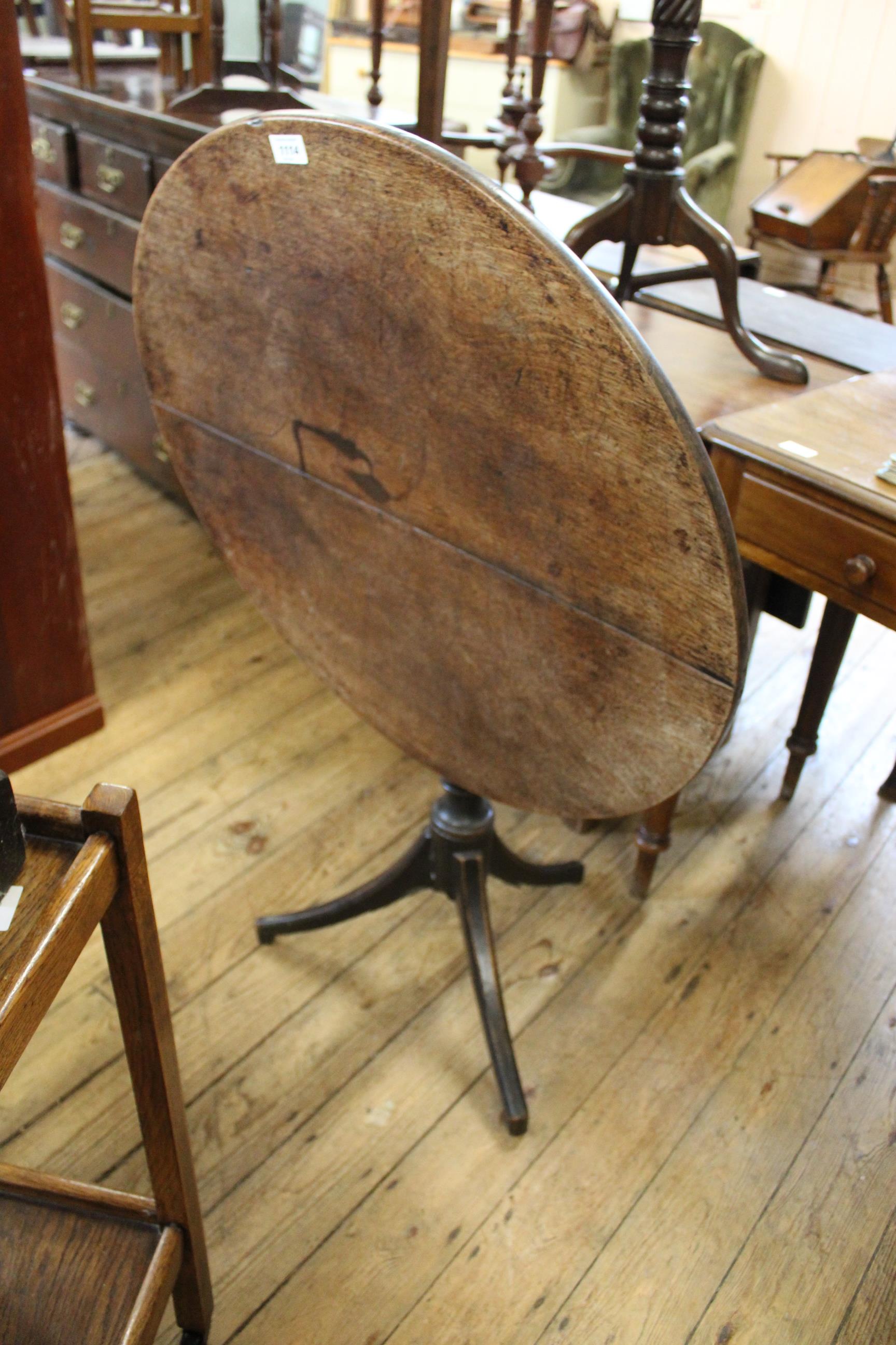 An early 19th Century oak and mahogany tilt top tripod table,