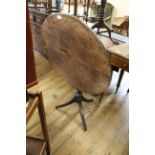 An early 19th Century oak and mahogany tilt top tripod table,
