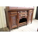 A carved walnut two door two drawer sideboard