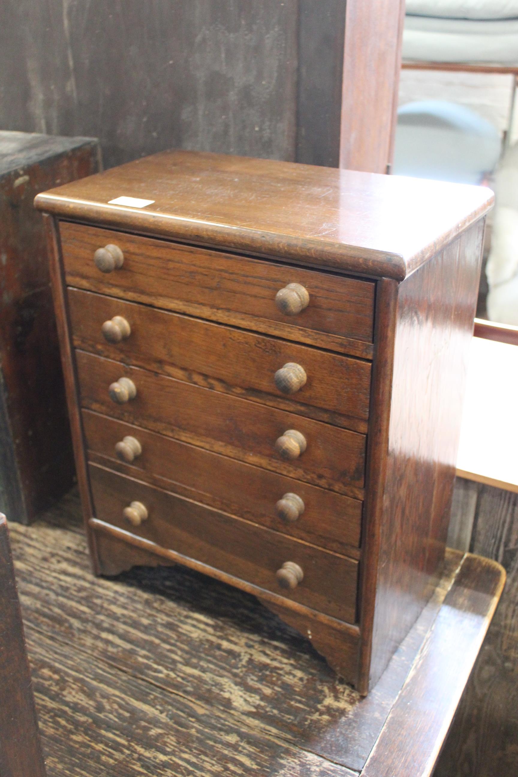 An early 20th Century oak collectors chest of five drawers, width 39cm x depth 23cm x height 48.