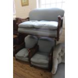 A 1920's mahogany upholstered bergere two seater settee together with two armchairs