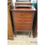 A late 19th Century carved mahogany six drawer music cabinet