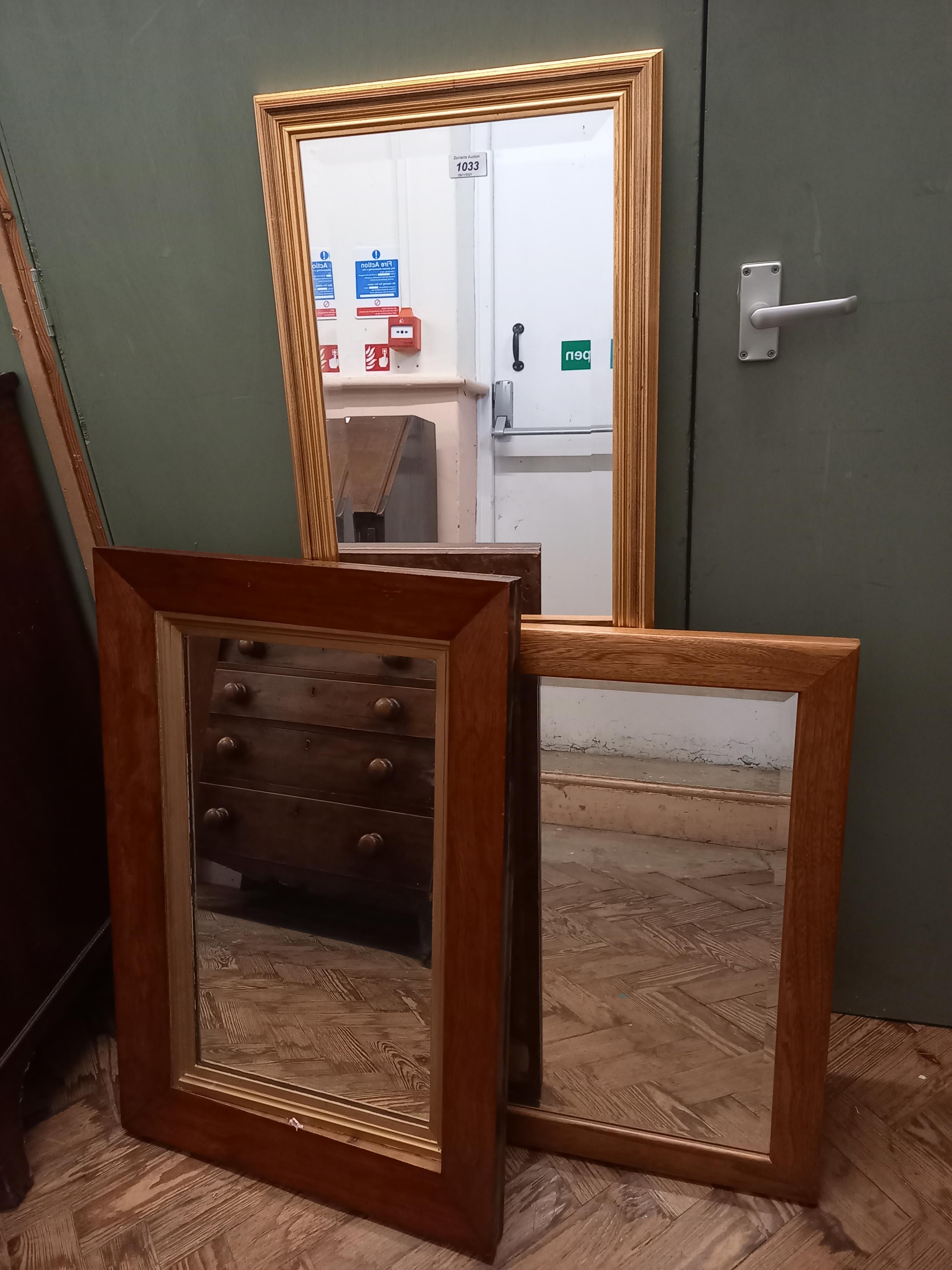 Three rectangular wooden framed mirrors of various sizes