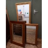 Three rectangular wooden framed mirrors of various sizes