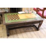 A 20th Century oak two drawer coffee table with late inlaid games top,