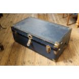 A vintage blue travelling trunk with brass hardware
